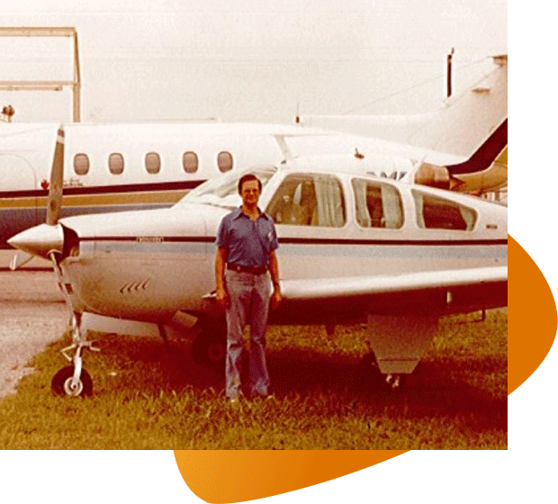 A photo of Huntly Millar with a plan behind him