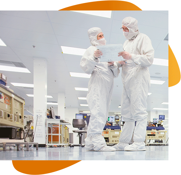 Two Millar scientists in scrubs look over a clinical clipboard