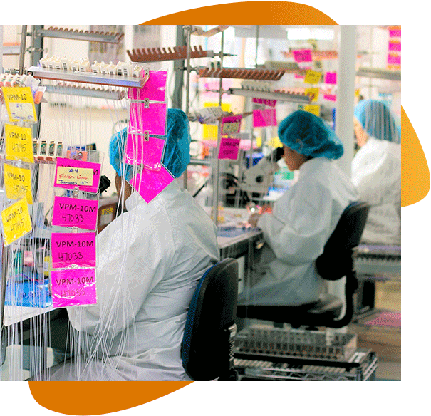 A group of female scientists surrounded by yellow and pink sticky notes work on proof of concept projects in a lab