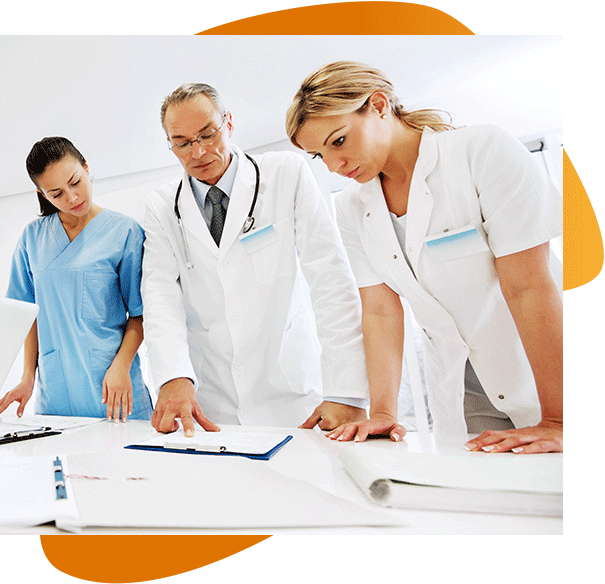 Two doctors and a nurse discuss an orthopedic data on a clipboard