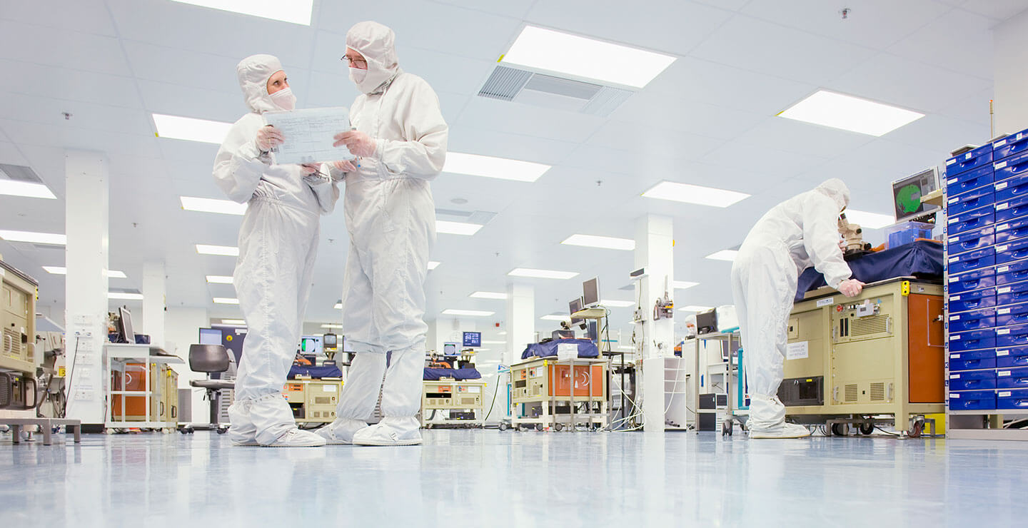 A large banner of a Millar research lab with two scientist looking over a clipboard